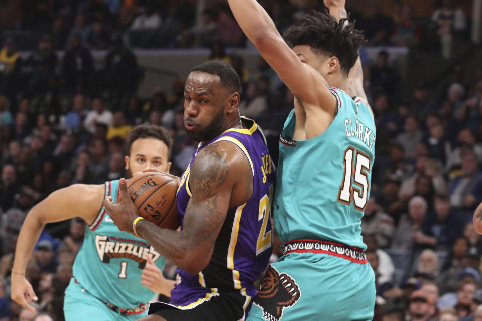 Memphis Grizzlies' Brandon Clarke (15) defends Los Angeles Lakers LeBron James (23) in the second half of an NBA basketball game Saturday, Nov. 23, 2019, in Memphis, Tenn. (AP Photo/Karen Pulfer Focht)