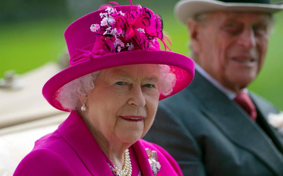 Queen Elizabeth II (L) and her husband Britain's Prince Philip, Duke of Edinburgh at Royal Ascot in 2014 - AFP 