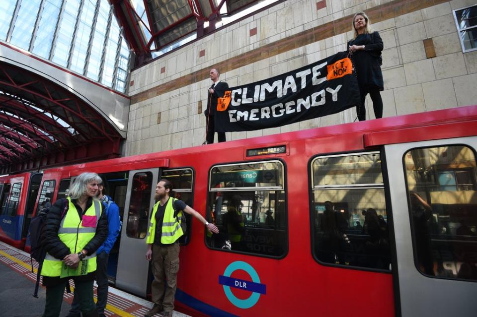 Climate activists protest on a Docklands Light Railway train in London (PA) (PA Archive)