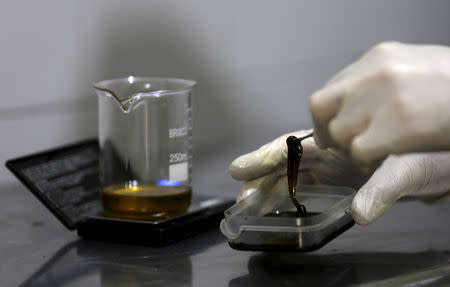 FILE PHOTO: Grower Denis Contry prepares medicinal oil with marijuana extract at Ganja Farms marijuana store in Bogota, Colombia January 7, 2016. REUTERS/John Vizcaino