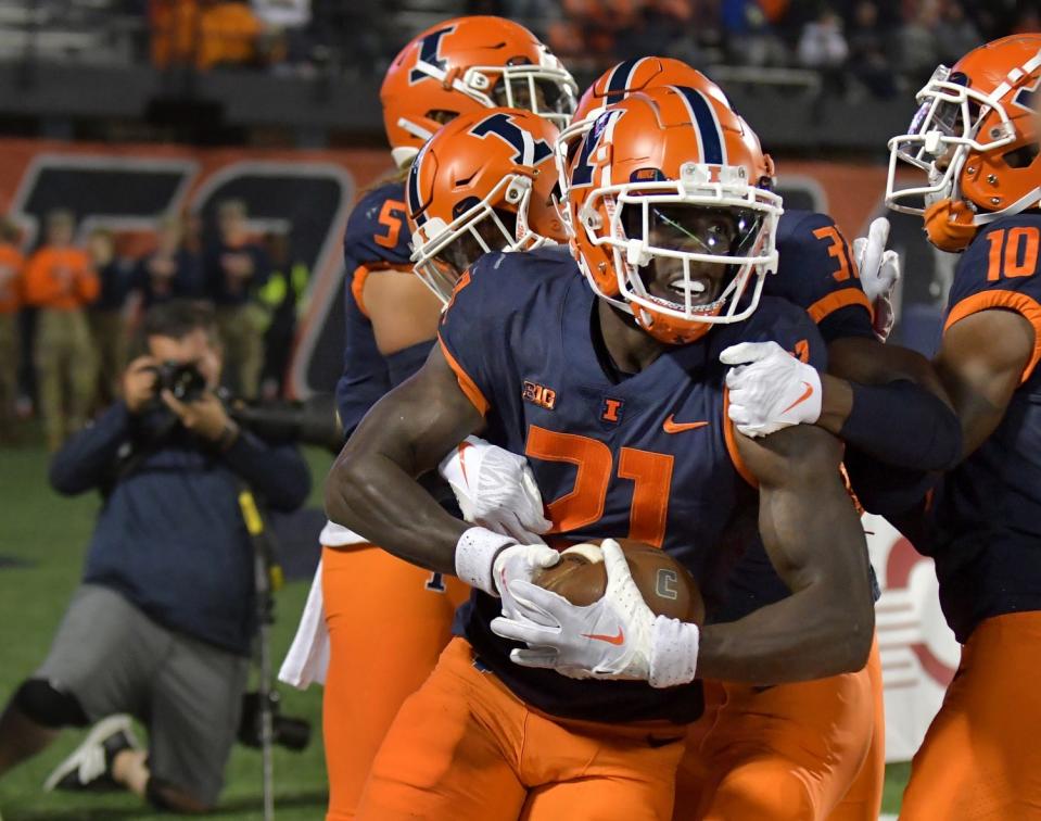 Illinois Fighting Illini defensive back Jartavius Martin (21) is congratulated by teammates after making an interception in the end zone against the Chattanooga Mocs during the first half at Memorial Stadium on Sept. 22, 2022.