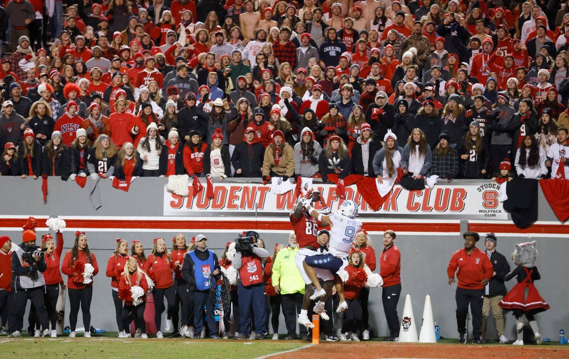 N.C. State wide receiver Emeka Emezie (86) makes what would be the game winning touchdown reception as North Carolina defensive back Cam’Ron Kelly (9) defends late in the second half of N.C. States 34-30 victory over UNC at Carter-Finley Stadium in Raleigh, N.C., Friday, November 26, 2021.