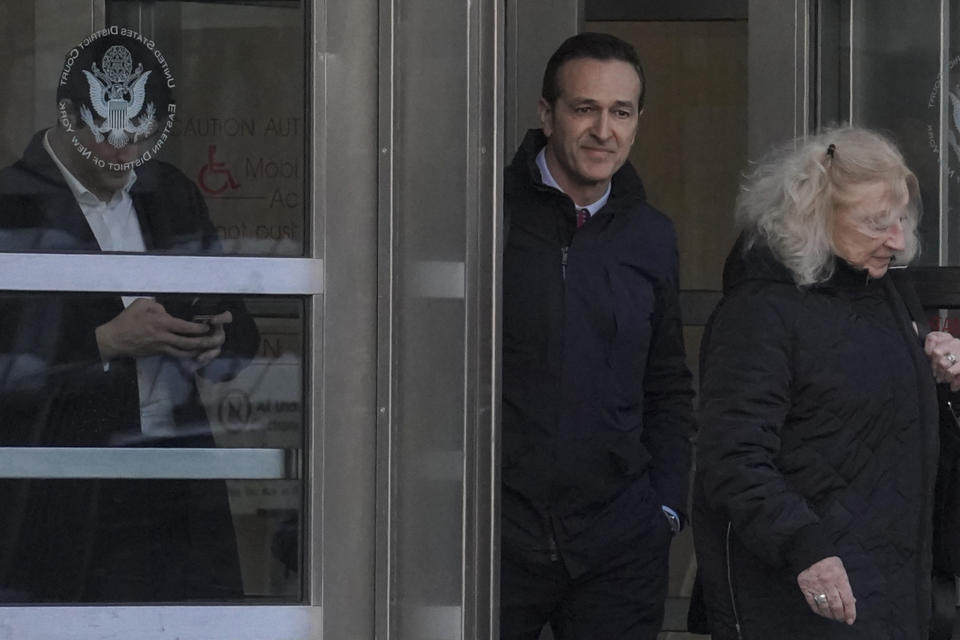 Former 21st Century Fox executive Hernan Lopez, center, leaves Brooklyn's Federal court, Monday March 6, 2023, in New York. A jury is deliberating after Lopez and fellow Fox sports executive Carlos Martinez, as well as a sports marketing company based in Argentina, were tried in a scheme to pay bribes to secure broadcasting rights to South America's premier club soccer tournament and to the World Cup. (AP Photo/Bebeto Matthews)