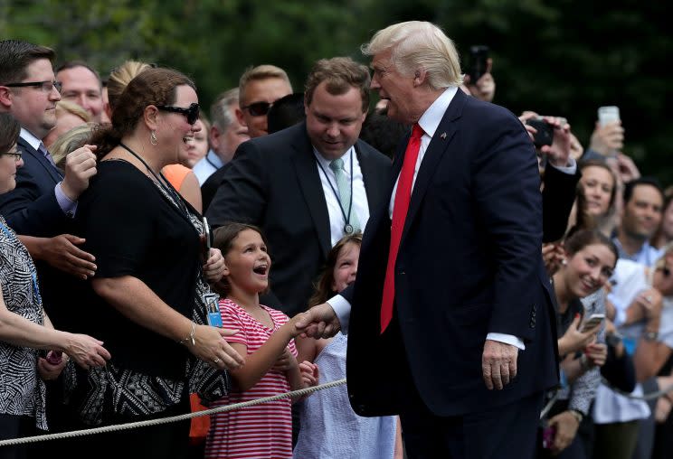 President Trump greets White House visitors las week after he landed on the South Lawn. 