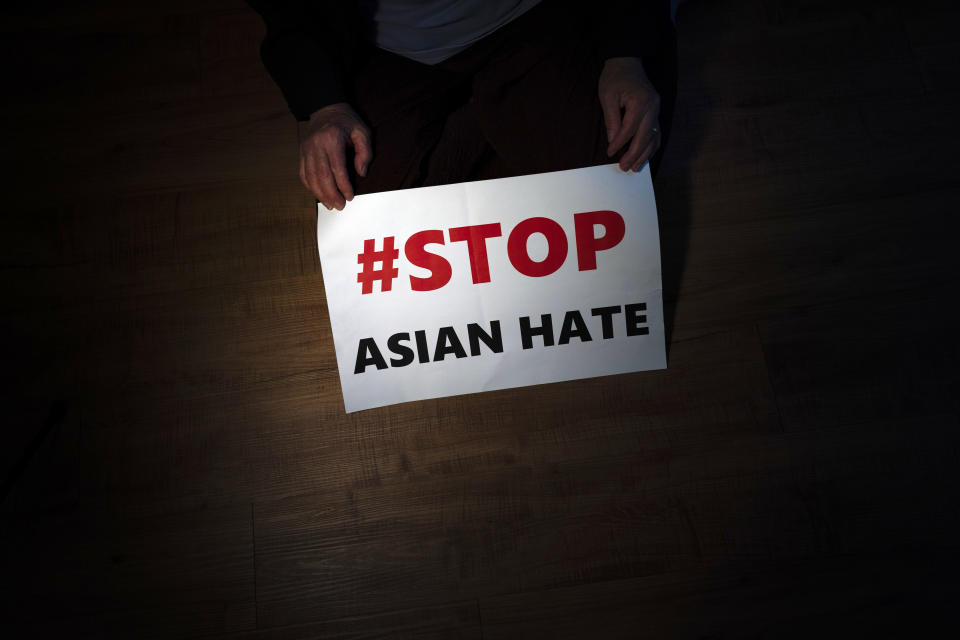 FILE - Jen Ho Lee, a 76-year-old South Korean immigrant, poses in her apartment in Los Angeles on March 31, 2021, with a sign from a recent rally against anti-Asian hate crimes she attended. Despite ongoing efforts to combat anti-Asian racism that arose after the pandemic, a third of Asian Americans and Pacific Islanders say they have experienced an act of abuse based on their race or ethnicity in the last year. (AP Photo/Jae C. Hong, File)