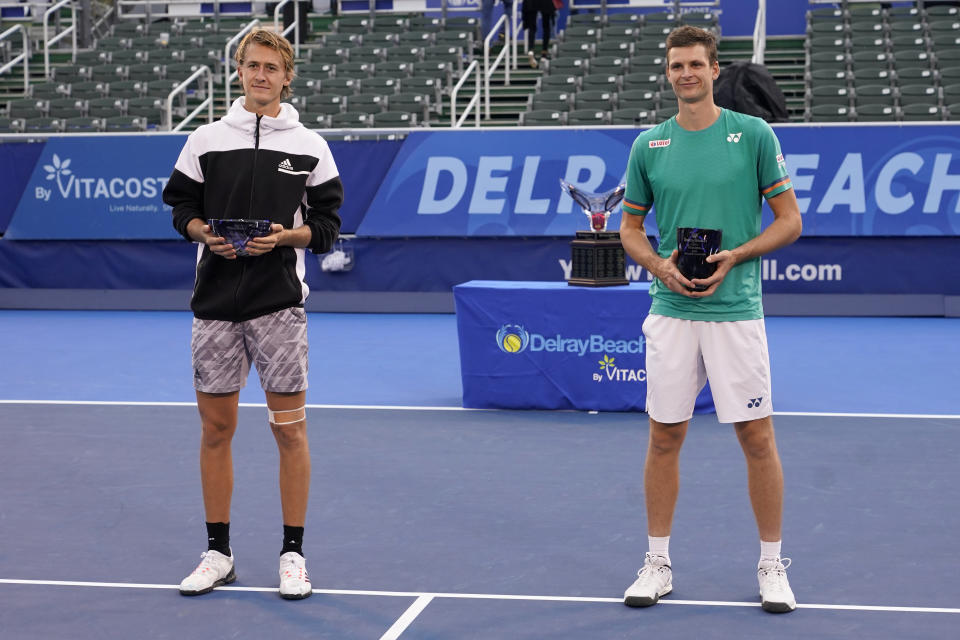 Sebastian Korda, left, and Hubert Hurkacz of Poland, right, pose with their trophy after the men's singles final of the Delray Beach Open tennis tournament, Wednesday, Jan. 13, 2021, in Delray Beach, Fla. Hurkacz won 6-3, 6-3. (AP Photo/Lynne Sladky)