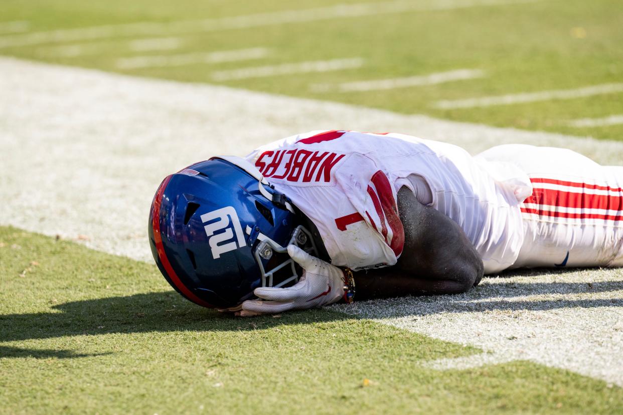 Sep 15, 2024; Landover, Maryland, USA; New York Giants wide receiver Malik Nabers (1) holds his face after dropping a pass against the Washington Commanders in the second half at Commanders Field. Mandatory Credit: Luke Johnson-Imagn Images