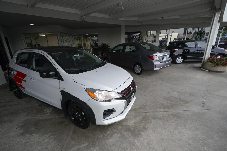 Three versions of the Mitsubishi Mirage sit for sale at El Cajon Mitsubishi on Tuesday, Aug. 8, 2023, in El Cajon, Calif. At a time when auto buyers increasingly want pricey SUVs and trucks and fewer want small cars, the Mirage remains the lone new vehicle whose average sale price is under 20 grand — a figure that once marked a kind of unofficial threshold of affordability. (AP Photo/Gregory Bull)