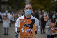 Health services members protest calling for a general strike and demanding more labor protection on their jobs in Madrid, Spain, Tuesday, Oct. 27, 2020. Spanish doctors are staging their first national walkout in 25 years to protest what they say are poor working conditions and the weakened state of the national public health system. (AP Photo/Manu Fernandez)