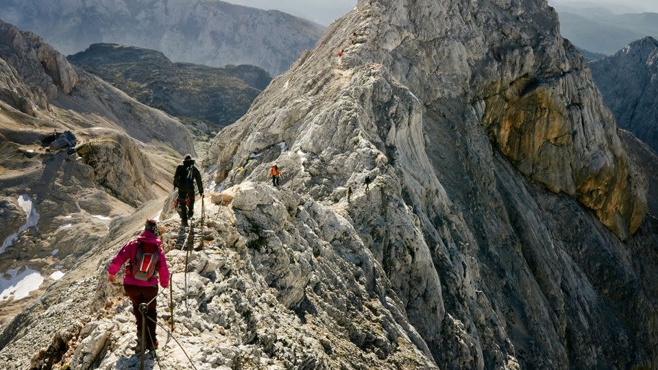 Mountaineers climbing ridge on Triglav mountain, Slovenia. - Enrique Ugarte/Moment RF/Getty Images