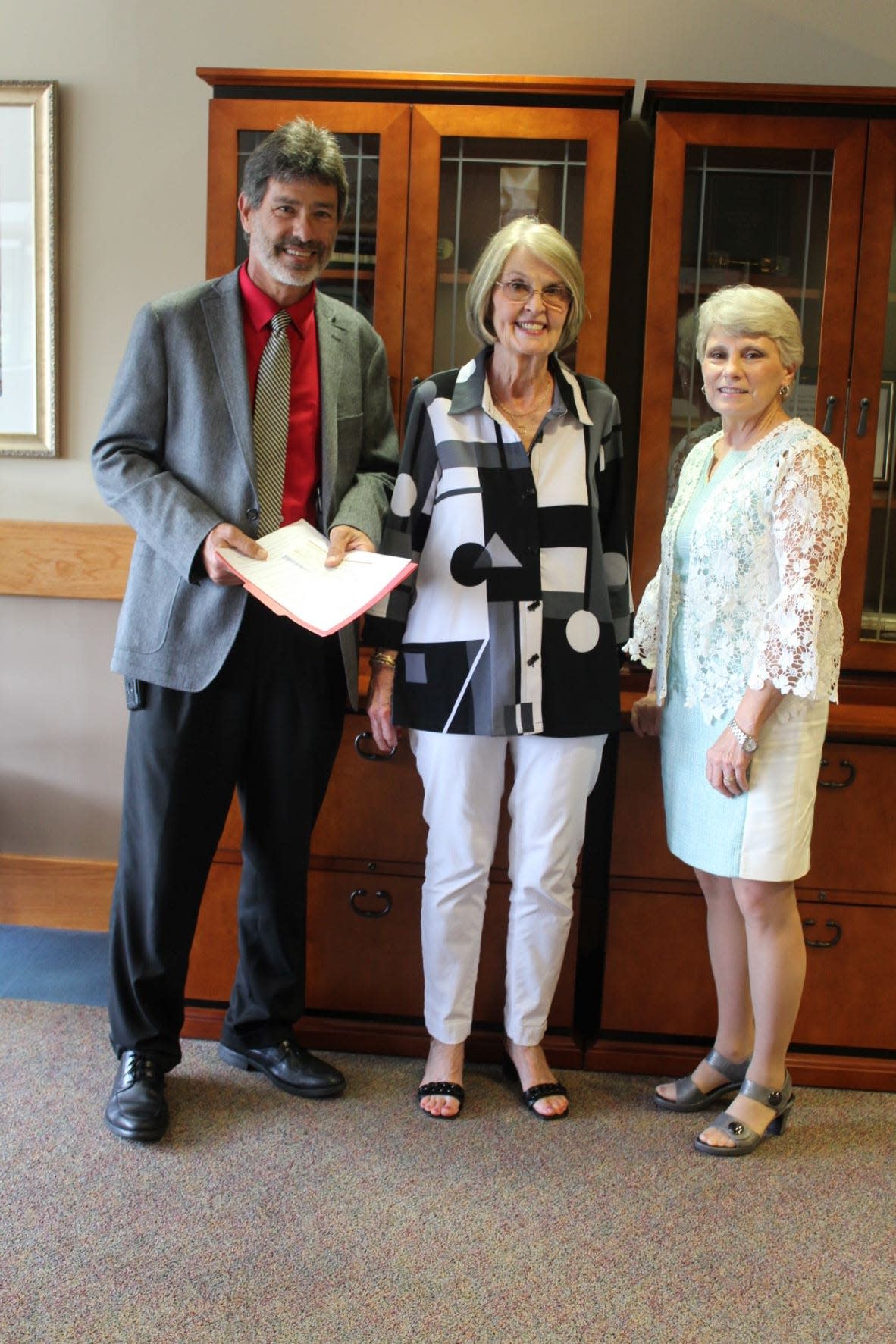 Dr. Kathy Murphy, president of GSCC, alongside the Whitaker family.