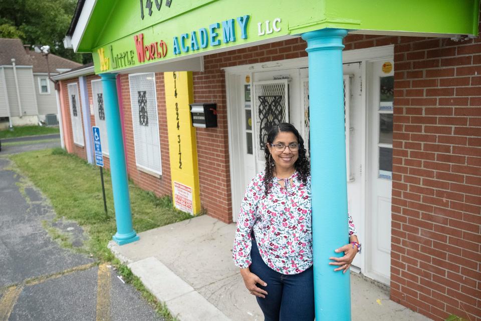 Aug 14, 2023; Columbus, OH, United States; Kenia Brito stand at the entrance to the My Little World Academy LLC Daycare where she is the Administrator. My Little World is in a partnership with Future Ready Columbus, which is hoping to improve early learning outcomes and kindergarten readiness by partnering with childcare centers like this one and offering them resources. Future Ready has already helped with is providing books for the children there.