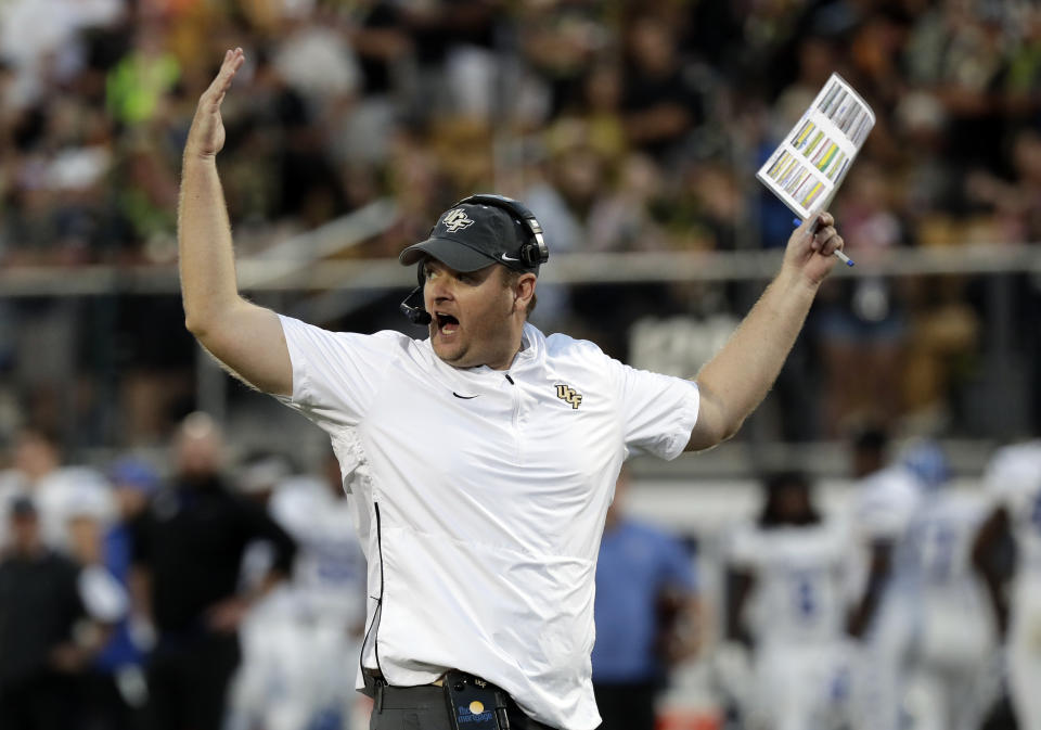 FILE - In this Dec. 1, 2018, file photo, Central Florida head coach Josh Heupel waves his arms during the first half of the American Athletic Conference championship NCAA college football game against Memphis, in Orlando, Fla. Heupel, Notre Dame’s Brian Kelly and Alabama’s Nick Saban are the finalists for The Associated Press national college football coach of the year after leading their teams to unbeaten regular seasons. The winner will be announced Monday, Dec. 17. (AP Photo/John Raoux, File)