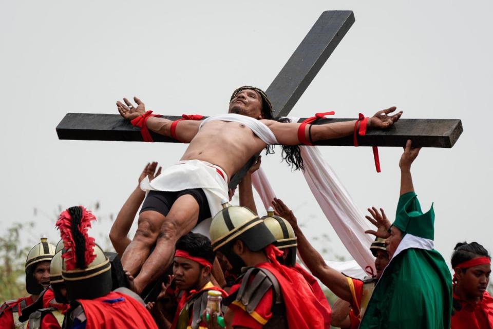 People get nailed to wooden crosses in the province of Pampanga in the Philippines at Easter