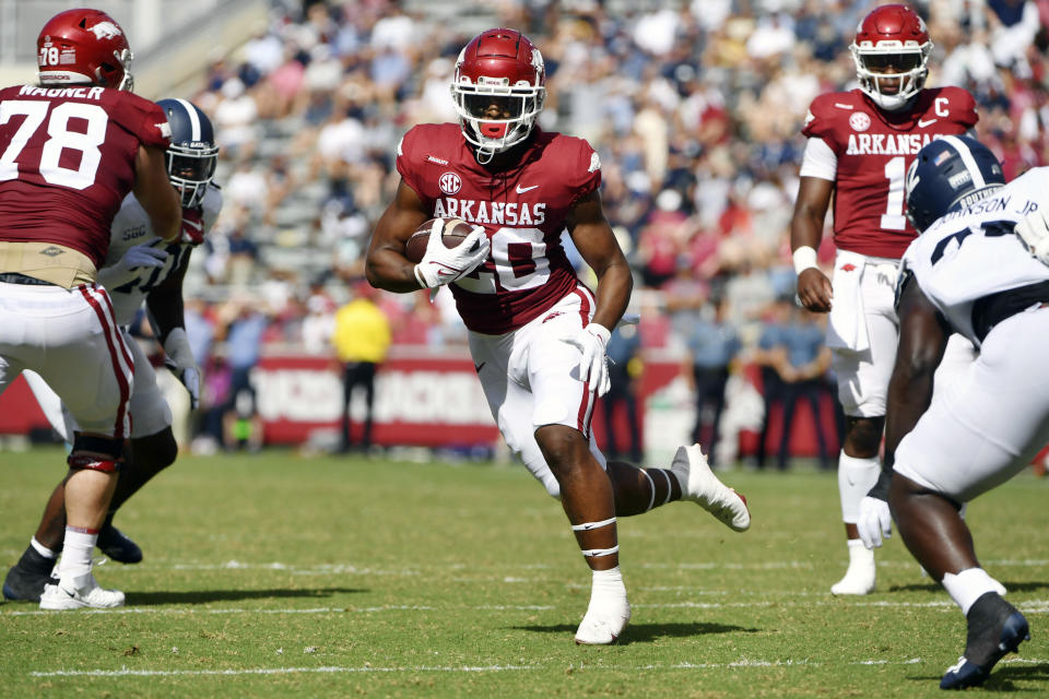 Arkansas running back Dominique Johnson (20) finds a hole in the Georgia Southern defense as he runs for a touchdown during the first half of an NCAA college football game Saturday, Sept. 18, 2021, in Fayetteville, Ark. (AP Photo/Michael Woods)