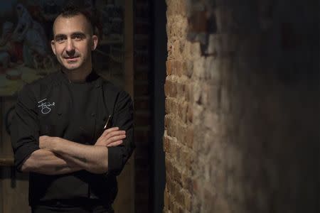 American chef Marc Forgione poses for a photo in his restaurant Marc Forgione in New York April 3, 2014. REUTERS/Brendan McDermid