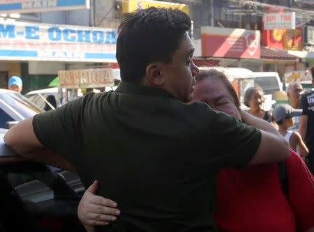 Relatives weep after learning their loved one was killed in a casino fire caused by a gunman at Resorts World in Pasay City, Metro Manila, Philippines June 2, 2017. Picture taken June 2, 2017. REUTERS/Stringer