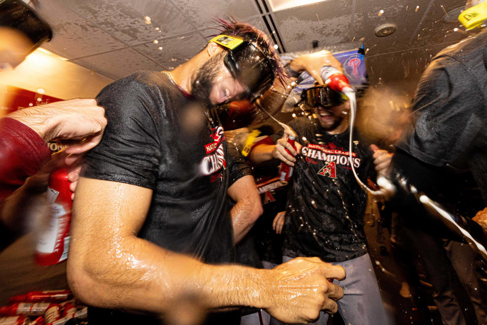 Diamondbacks players celebrate in the clubhouse after winning Game 7 against the Phillies.