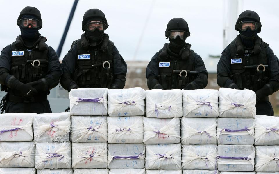 Members of the navy stand behind what is believed to be around 80 million euro (£62.5 million) worth of cocaine  - Credit: PA