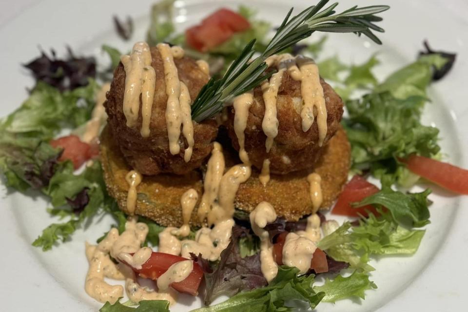 The new restaurant features jumbo lump crab cakes with asparagus, red onion arugula salad and lemon olive oil.