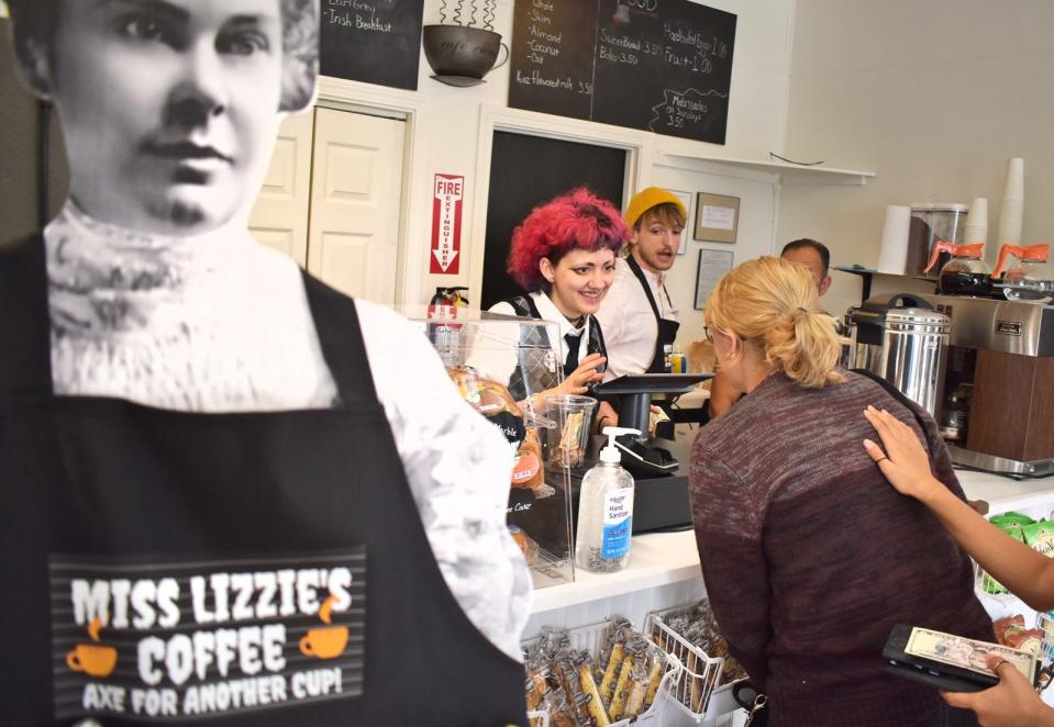 Olivia Pereira, daughter of owner Joe Pereira, serves a customer at the new Miss Lizzie's Coffee Shop in Fall River.