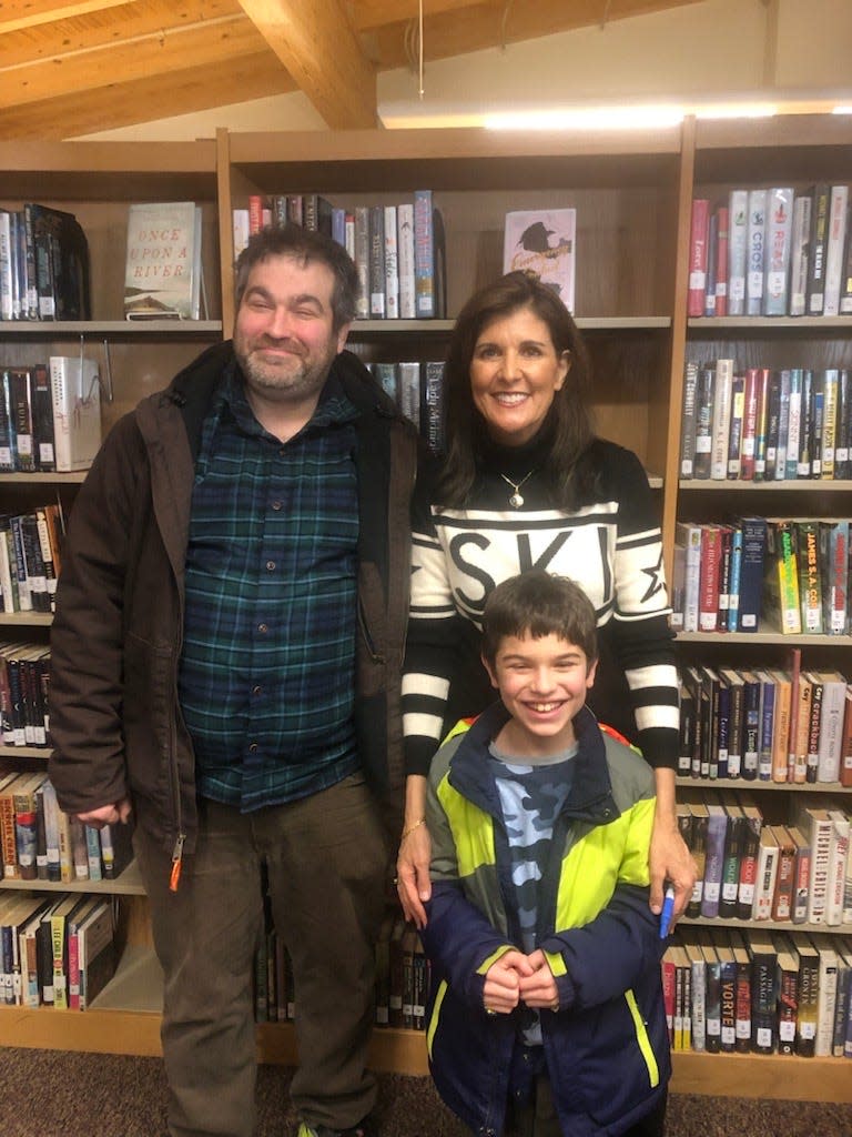 Adam Grossman and his father, Steve, meet with Nikki Haley after her event in North Conway on Dec. 28, 2023.