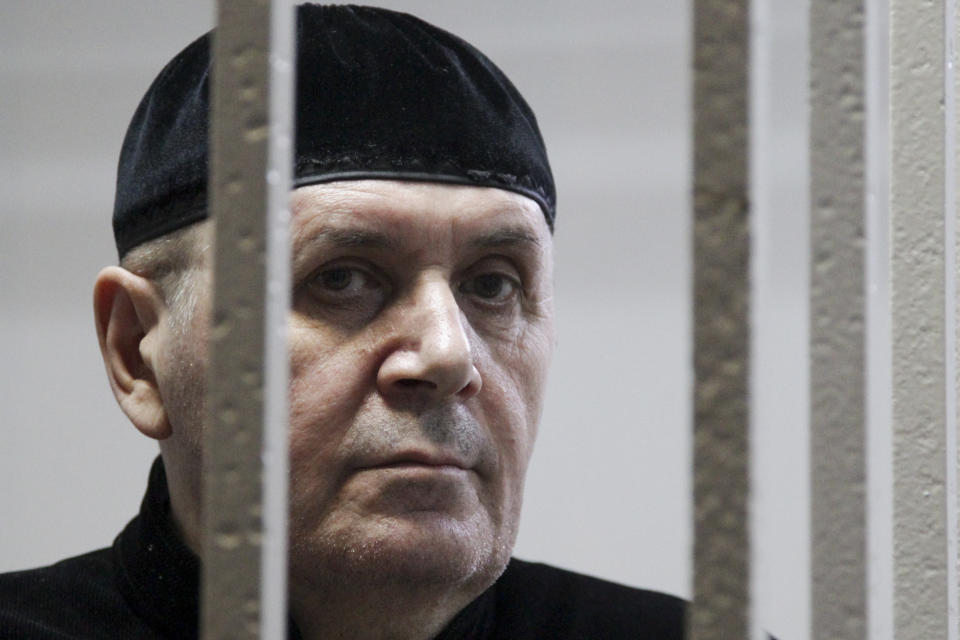 Oyub Titiev, the head of a Chechnya branch of the prominent human rights group Memorial, stands behind bars in court before a hearing in Shali, Russia, Monday, March 18, 2019. Oyub Titiyev was detained in January 2018 and charged with drug possession in what has been largely perceived as a vendetta against this rare critic of the Chechen government. The court is due to issue its verdict Monday. (AP Photo/Musa Sadulayev)