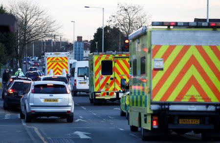 Nurse Pauline Cafferkey is driven an away by ambulance in a convoy after landing at Northolt just west of London, February 23, 2016. REUTERS/Peter Nicholls