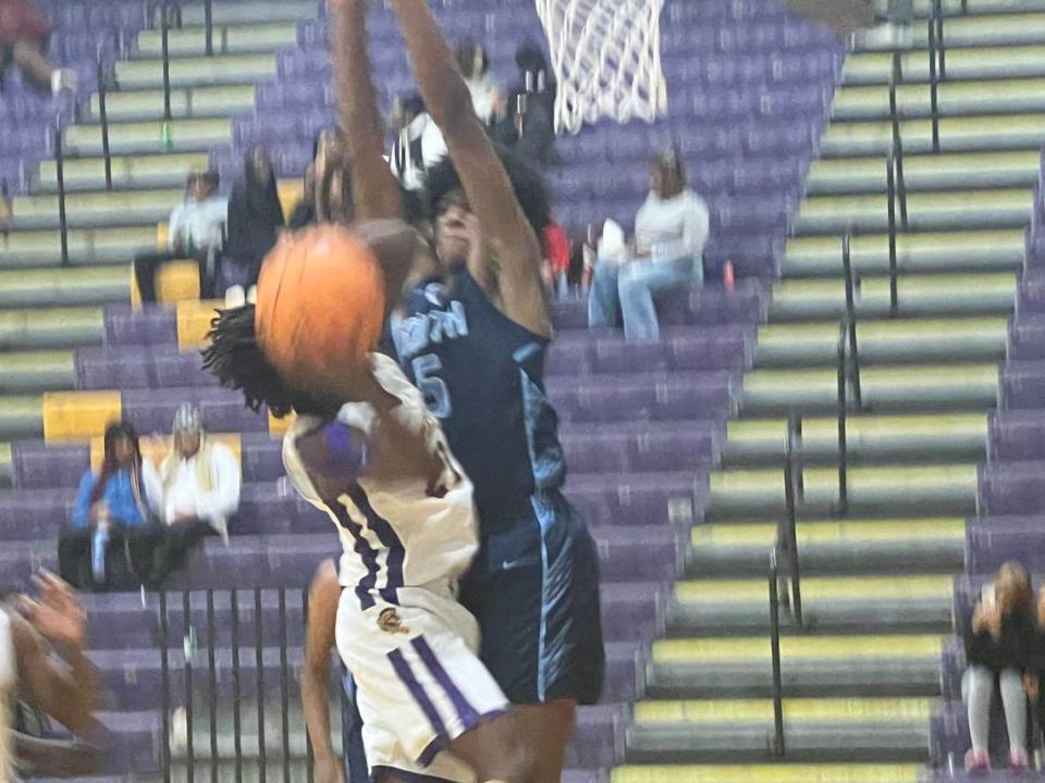 Northwestern’s Erick Jordan (21, white) gets fouled going up for a layup against South Florence’s Jarius Davis (5, blue) in the first-half of Northwestern’s 64-50 win over South Florence on Dec. 2 at the Battle of the Rock basketball showcase.