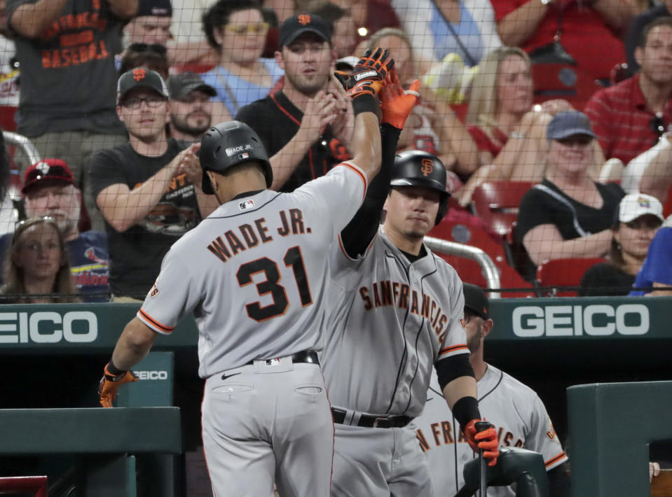 San Francisco Giants' LaMonte Wade Jr. (31) celebrates with Wilmer Flores after hitting a three-run home run in the fifth inning of the team's baseball game against the St. Louis Cardinals, Friday, July 16, 2021, in St. Louis. (AP Photo/Tom Gannam)