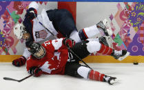 Kelli Stack of the United States (16) collides with Haley Irwin of Canada (21) during the first period of the women's gold medal ice hockey game at the 2014 Winter Olympics, Thursday, Feb. 20, 2014, in Sochi, Russia. (AP Photo/Julio Cortez)