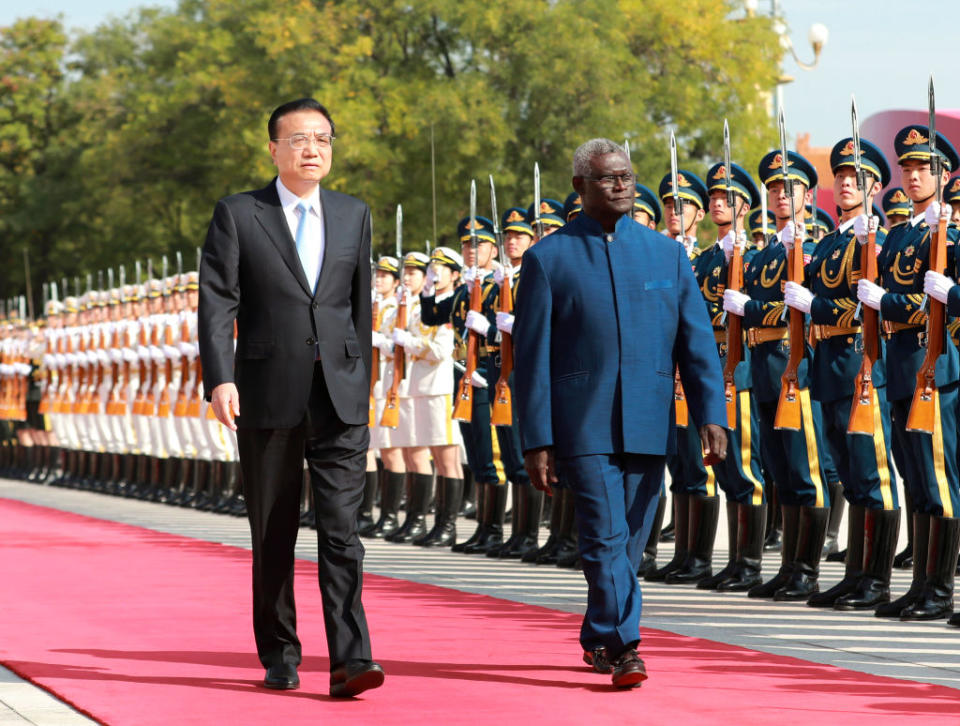 Chinese Premier Li Keqiang holds a welcoming ceremony for Solomon Islands' Prime Minister <span class="caas-xray-inline-tooltip"><span class="caas-xray-inline caas-xray-entity caas-xray-pill rapid-nonanchor-lt" data-entity-id="Manasseh_Sogavare" data-ylk="cid:Manasseh_Sogavare;pos:1;elmt:wiki;sec:pill-inline-entity;elm:pill-inline-text;itc:1;cat:OfficeHolder;" tabindex="0" aria-haspopup="dialog"><a href="https://search.yahoo.com/search?p=Manasseh%20Sogavare" data-i13n="cid:Manasseh_Sogavare;pos:1;elmt:wiki;sec:pill-inline-entity;elm:pill-inline-text;itc:1;cat:OfficeHolder;" tabindex="-1" data-ylk="slk:Manasseh Sogavare;cid:Manasseh_Sogavare;pos:1;elmt:wiki;sec:pill-inline-entity;elm:pill-inline-text;itc:1;cat:OfficeHolder;" class="link ">Manasseh Sogavare</a></span></span> ahead of their talks at the Great Hall of the People in Beijing, capital of China, Oct. 9, 2019. Sogavare is paying an official visit to China. /Xinhua via Getty) (Xinhua/Pang Xinglei via Getty Images)<span class="copyright">Pang Xinglei—Xinhua News Agency/Getty Images</span>