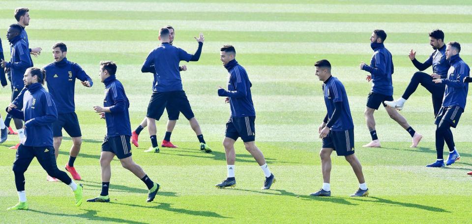 Juventus' Cristiano Ronaldo, 5th from right, warms up with teammates during a training session ahead of Wednesday's Champions League soccer match against Atletico Madrid, in Turin, Tuesday, Feb. 19, 2019. (Alessandro Di Marco/ANSA via AP)