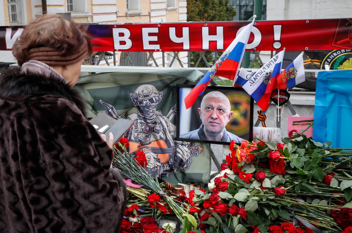 A woman stands in front of an informal memorial to PMC Wagner chief Yevgeny Prigozhin in Moscow (EPA)