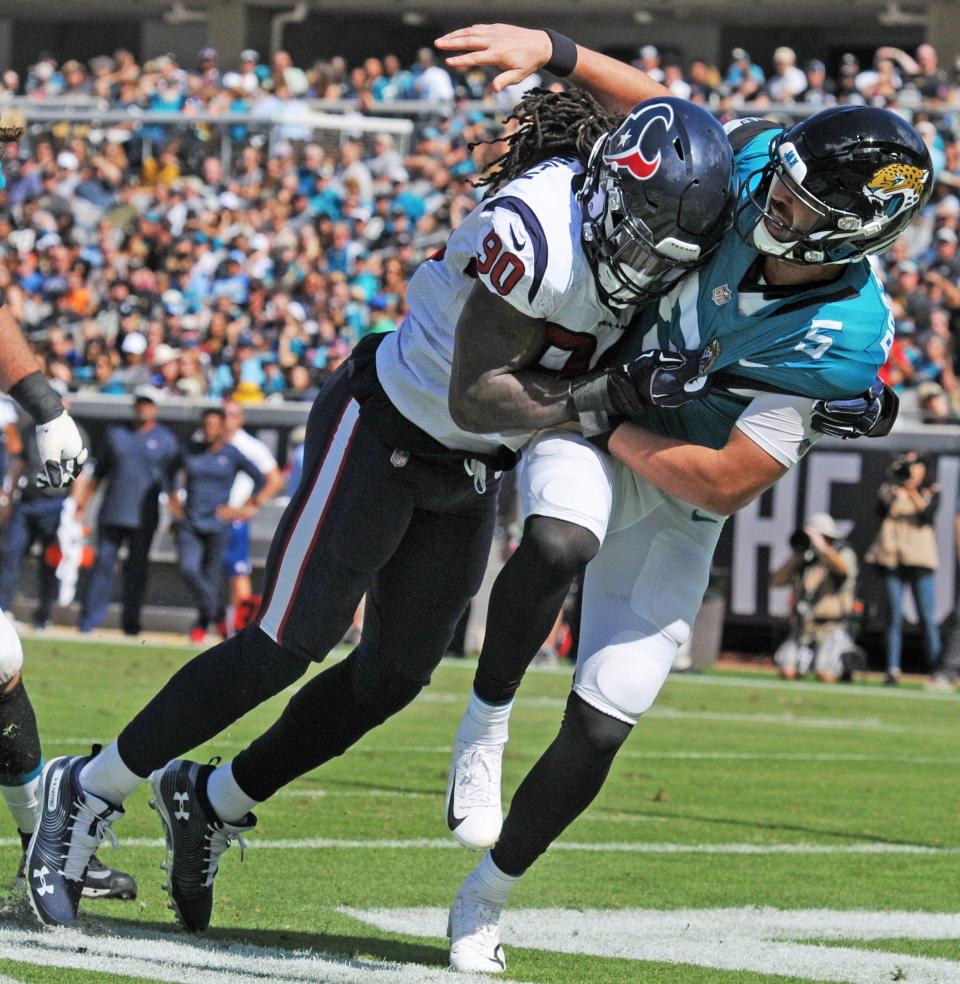 Jacksonville Jaguars quarterback Blake Bortles (5) gets slammed to the turf on a pass attempt by Houston Texans linebacker Jadeveon Clowney (90) during late second quarter action. The Jacksonville Jaguars hosted the Houston Texans Sunday, October 21, 2018 at TIAA Bank Field in Jacksonville, FL. The Jaguars trailed 13 to 0 at the half. [Bob Self/Florida Times-Union]