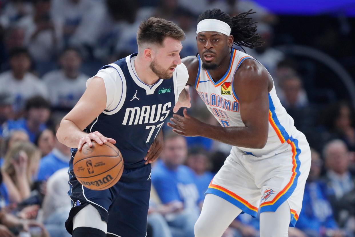 Oklahoma City Thunder guard Luguentz Dort (5) defends Dallas Mavericks guard Luka Doncic (77) during Game 1 of the Western Conference semifinals NBA playoff game between the Oklahoma City Thunder and the Dallas Mavericks at Paycom Center in Oklahoma City, Tuesday, May 7, 2024.