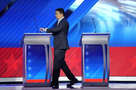 Entrepreneur Andrew Yang checks his watch during a break at the 2020 Democratic U.S. presidential debate in Houston, Texas, U.S.