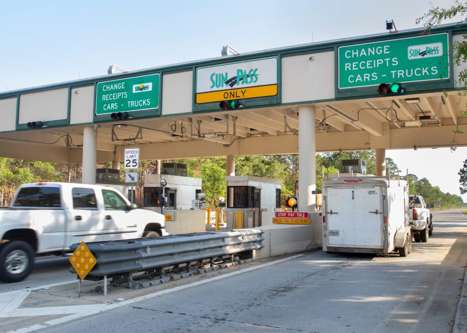 Vehicles pass through the Garcon Point Bridge toll plaza in Santa Rosa County on May 4. The Florida Department of Transportation has agreed to pay $134 million to take control of the bridge.