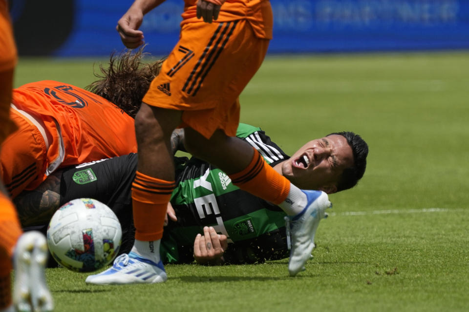 Austin FC's Sebastián Driussi right, is tackled by Houston Dynamo's Tim Parker (5) during the second half of a MLS soccer match Saturday, April 30, 2022, in Houston. Austin FC won 2-1. (AP Photo/David J. Phillip)