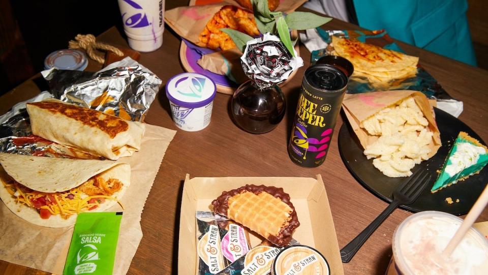 A table with a wide varriety of Taco Bell related foods
