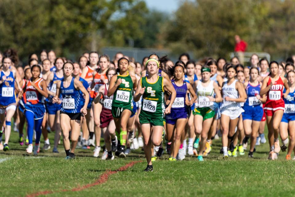 The start of the girls 1A 3200 meter race.  Taytum Goodman of Earth Springlake (1028) took the early lead on the way to her third straight title. The Texas UIL State Cross Country Championships were held at Old Settlers Park in Round Rock on November 4-5, 2022.