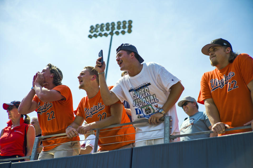 Virginia fans celebrate after winning Game 2 at the NCAA college baseball tournament super regional against Duke, Saturday, June 10, 2023, in Charlottesville, Va. (AP Photo/John C. Clark)