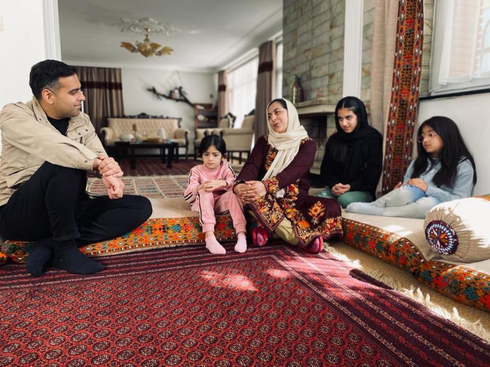 Afghan   obstetrician Najmussama Shafaj sits with her three daughters as she speaks with CBS News correspondent Imtiaz Tyab at her home in Kabul, Afghanistan. / Credit: CBS News