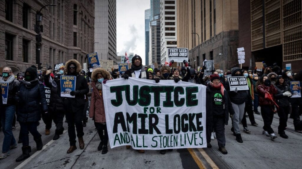 Demonstrators march behind a banner reading “Justice for Amir Locke and All Stolen Lives” during a rally in protest of the killing of Amir Locke, outside the Hennepin County Government Center in Minneapolis, Minnesota on February 5, 2022. (Photo by Kerem Yucel / AFP) (Photo by KEREM YUCEL/AFP via Getty Images)