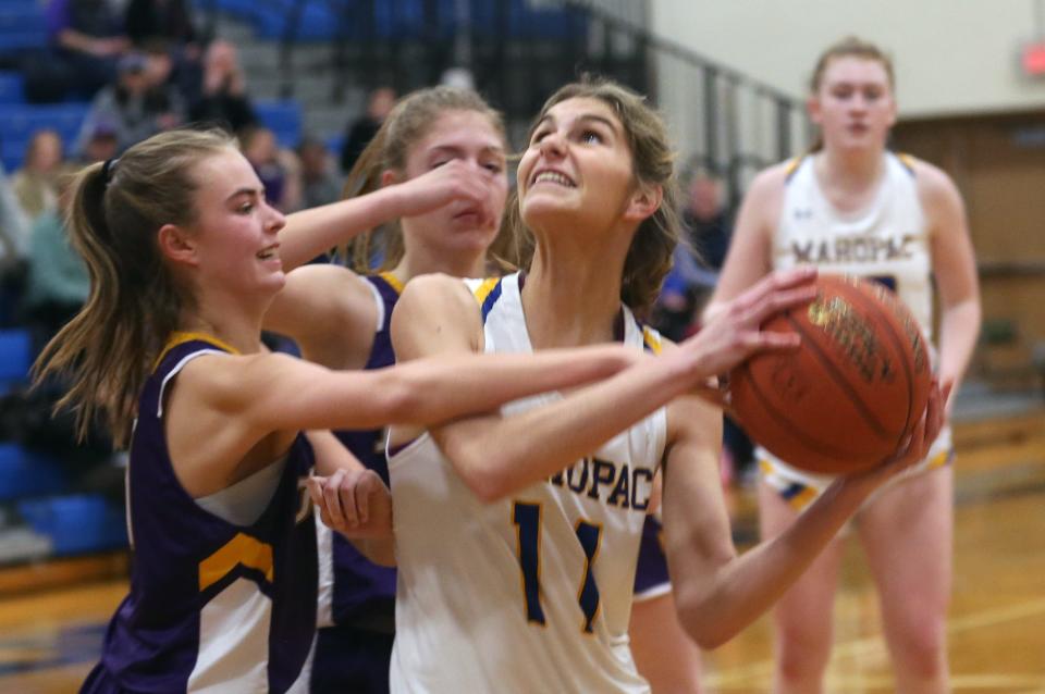 Mahopac's Lauren Beberman (11) puts up a shot in front of  John Jay's Mranda Martin (33) during a girls basketball Class A playoff game at Mahopac High School Feb. 23, 2023. Mahopac won the game 66-37.