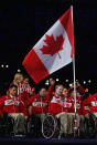 LONDON, ENGLAND - AUGUST 29: Wheelchair Rugby player Garrett Hichling of Canada carries the flag during the Opening Ceremony of the London 2012 Paralympics at the Olympic Stadium on August 29, 2012 in London, England. (Photo by Clive Rose/Getty Images)