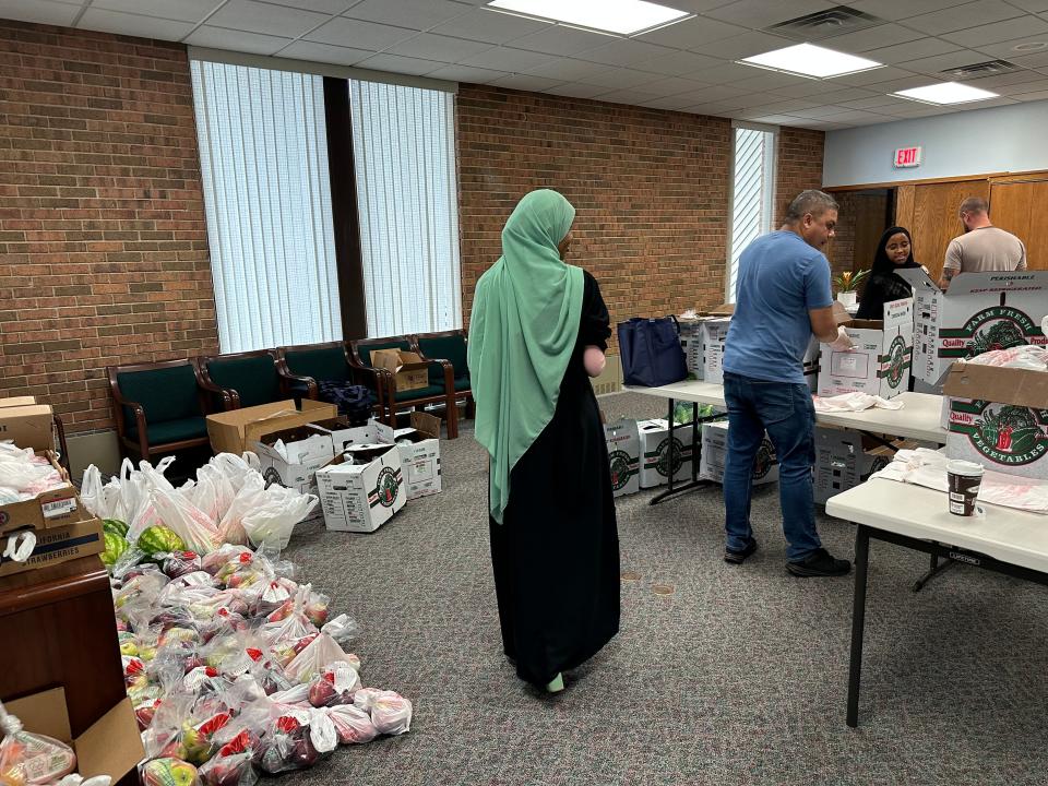 Members of the COMSA team prepare bags for their clients as part of a Wello Cultivating Community produce drop last year.