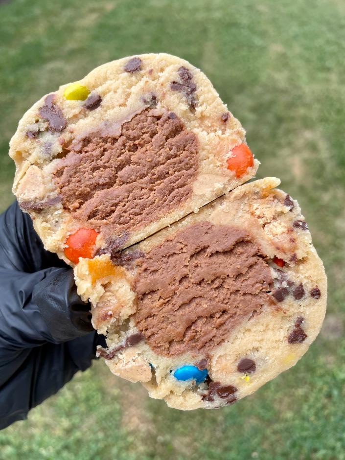 The All In cookie is a brown sugar base with M&amp;M’s, peanut butter chips, caramel bits, and mini chocolate chips. It's also stuffed with a mix of cookie butter, peanut butter, Nutella and Dulce de Leche, and it's topped with a chocolate drizzle.