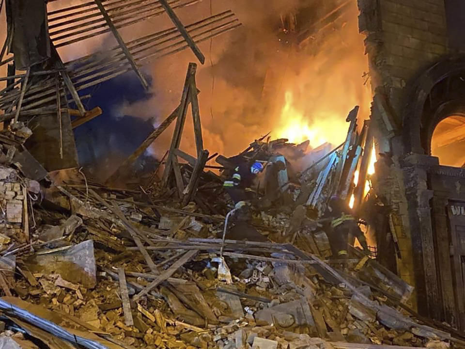 In this photo provided by the Ukrainian Emergency Service, rescuers work at the scene of a building damaged by shelling in Zaporizhzhia, Ukraine, Thursday, Oct. 6, 2022. (Ukrainian Emergency Service via AP )