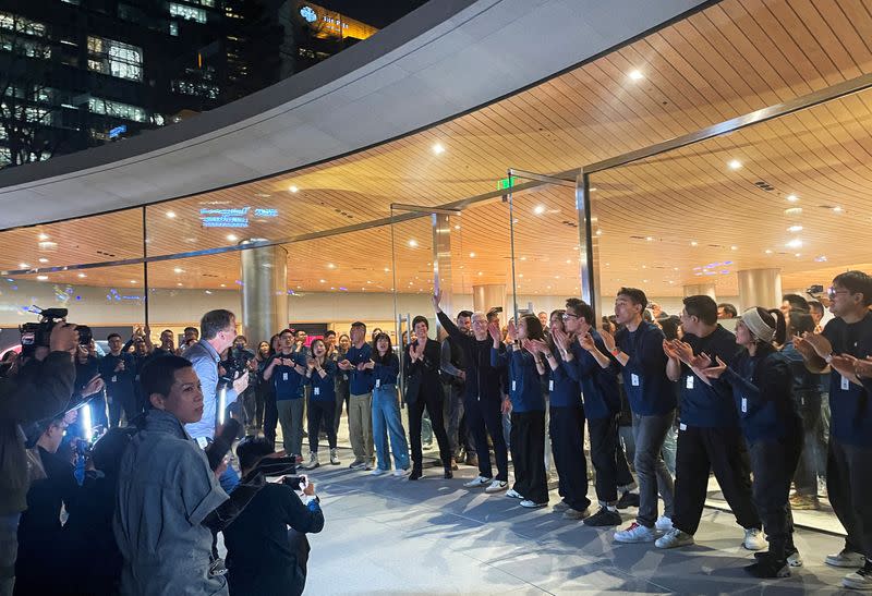 Apple CEO Tim Cook arrives at the new Apple store for its opening, in Shanghai